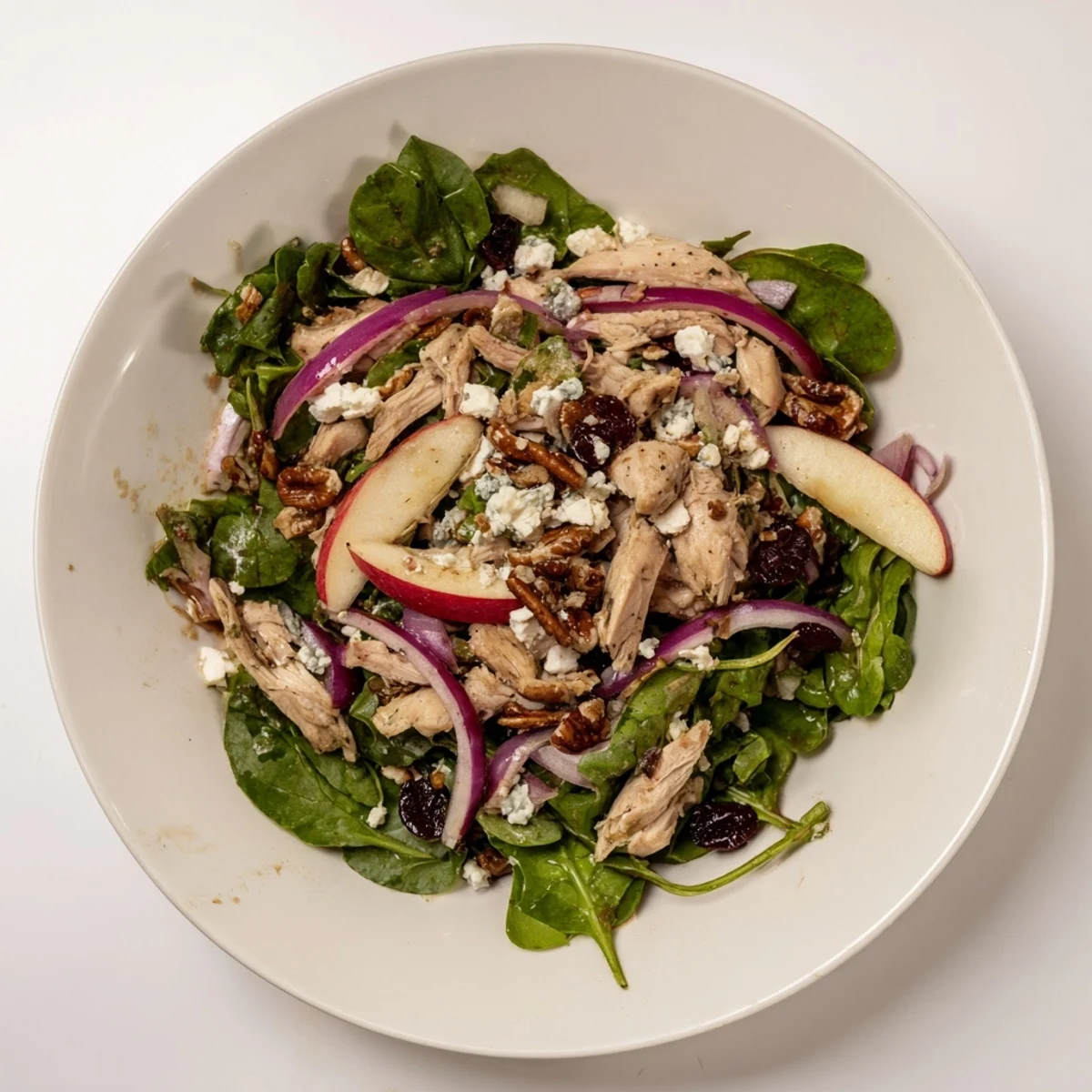 This colorful Chicken and Apple Winter Salad features juicy chicken, pecans, and a tangy apple cider dressing.