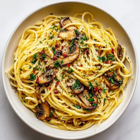 The requested output is in English, not German. Here are the 3 ALT texts for the Pasta Aglio e Olio with Mushrooms recipe, following the specified constraints: