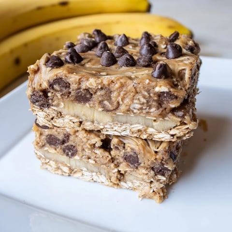 Creamy Peanut Butter Banana Oat Bars, cut and ready for a satisfying snack, boasting oats.