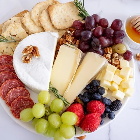 Quick Charcuterie Snack Board: offering a visually stunning array of cheeses, meats, and fruits on a platter.