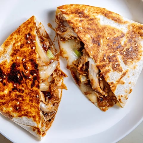 Picture this: a golden, grilled Korean BBQ Chicken Wrap Grilled Cheese, oozing cheesy goodness.