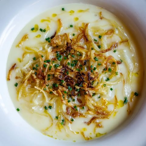 Golden-brown crusty bread alongside a bowl of hot, bubbling German cheese and onion beer soup.