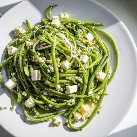 Fresh English Ivy salad, showing snap peas and cheese, tossed in a light dressing, a refreshing dish.