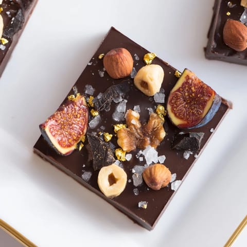 "Imagine the Midnight Mosaic: dense dark chocolate squares studded with figs and olives, ready to serve."