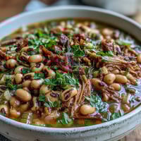 Schüssel mit zarten schwarzen Augen Erbsen, gewürzt mit Rauchpfeffer und frischem Petersilien topping, traditionell zum neuen Jahr serviert.  